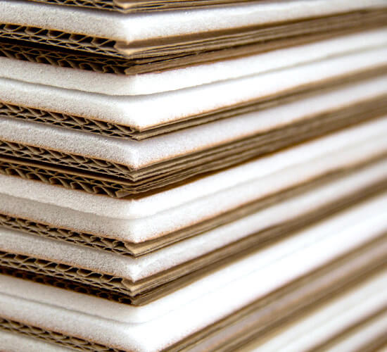 Foam-laminated corrugated sheets stacked for shipment